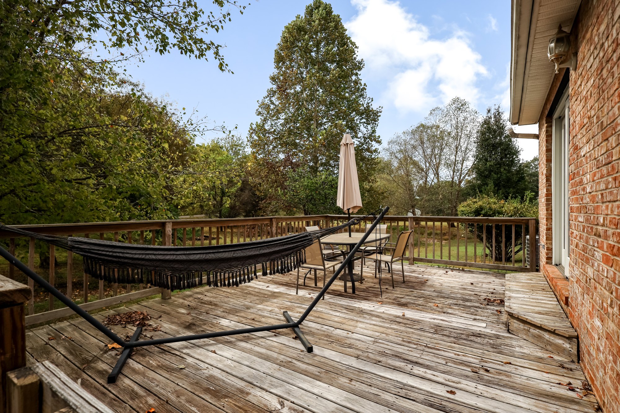 Deck and garden seating beside the brick exterior