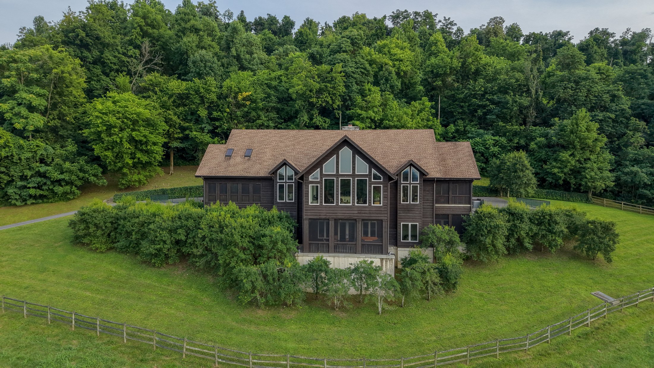 A timber home tucked into wooded hills. Warm interiors, generous porches, a guest cabin, and a landscape that unfolds around it. A selected photographic study of Blue Stocking Hollow.