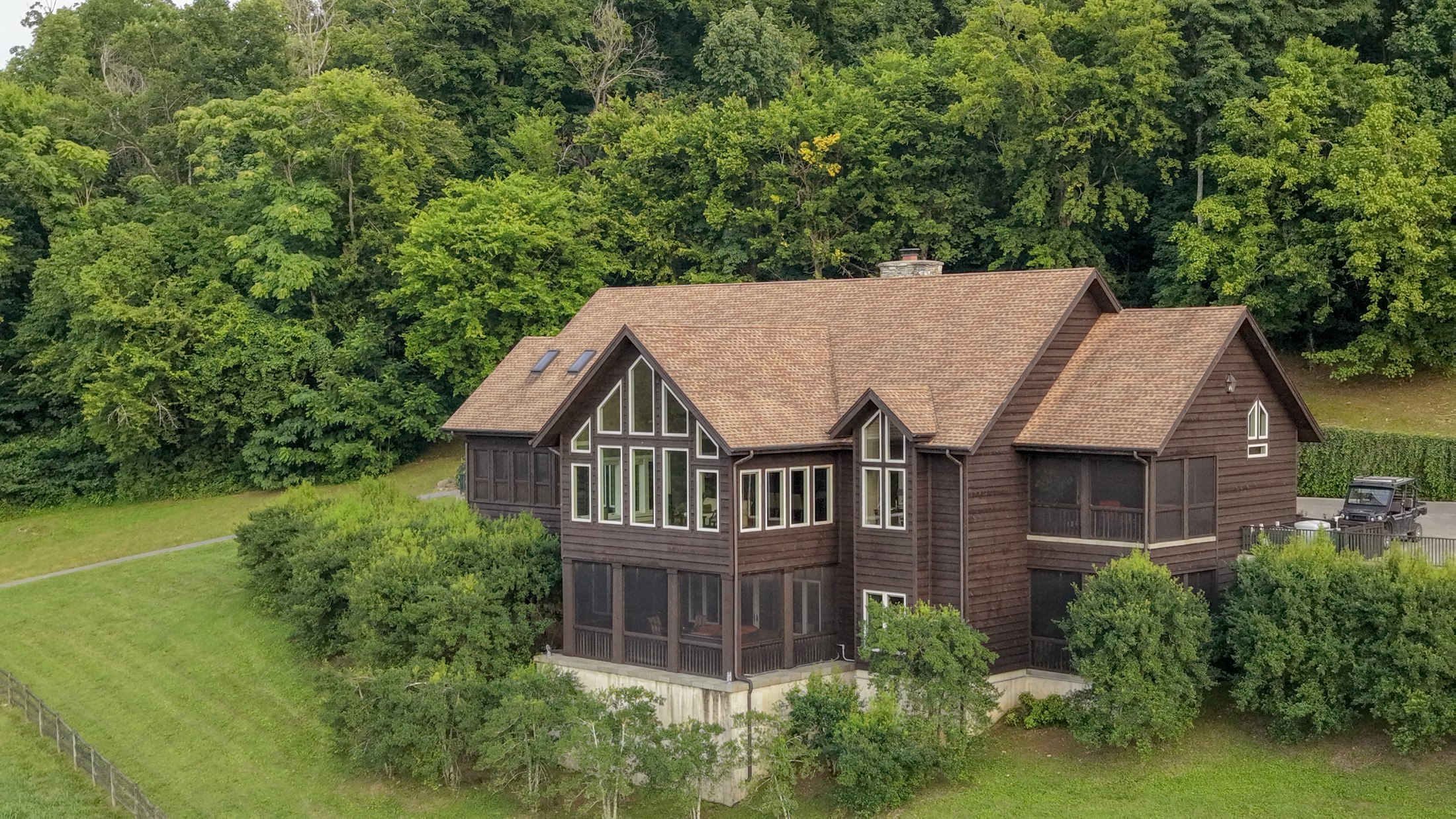 Oblique aerial view of the house and window-lined living room