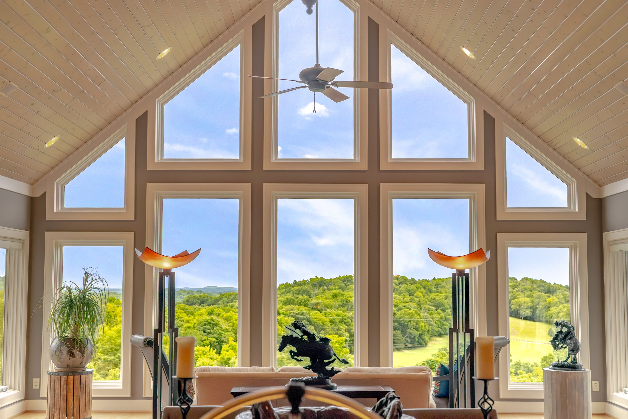 Window-lined room overlooking the green hillside
