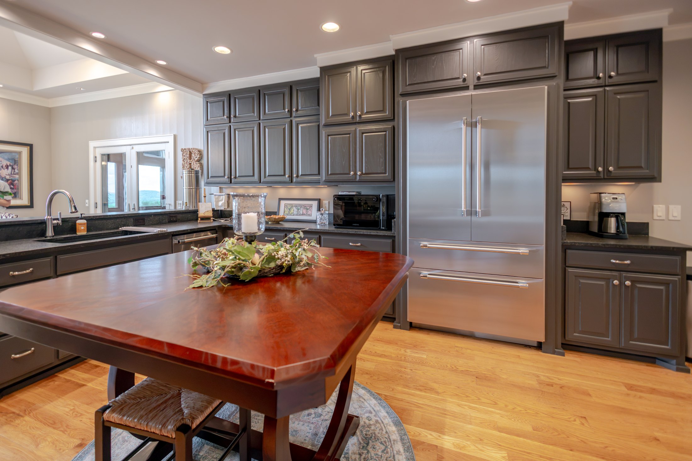 Kitchen with dark cabinetry and wood island