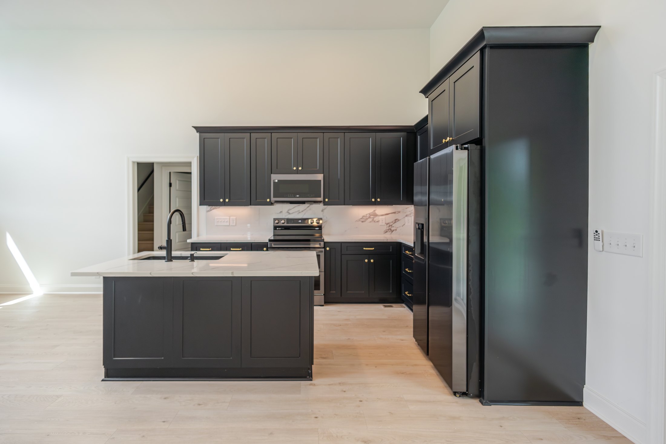 Kitchen with charcoal cabinetry and a central island