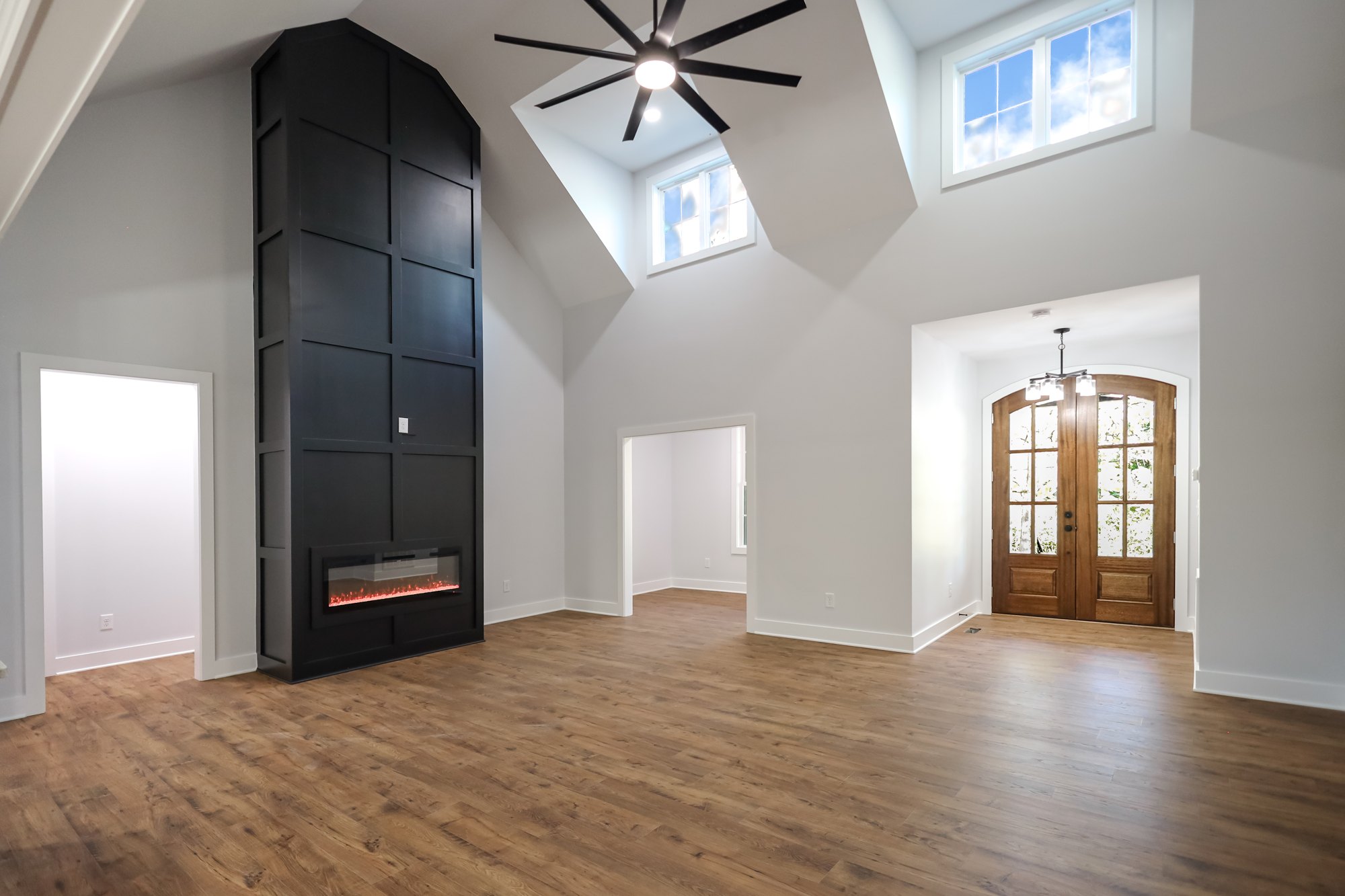 Tall living room with a dark fireplace