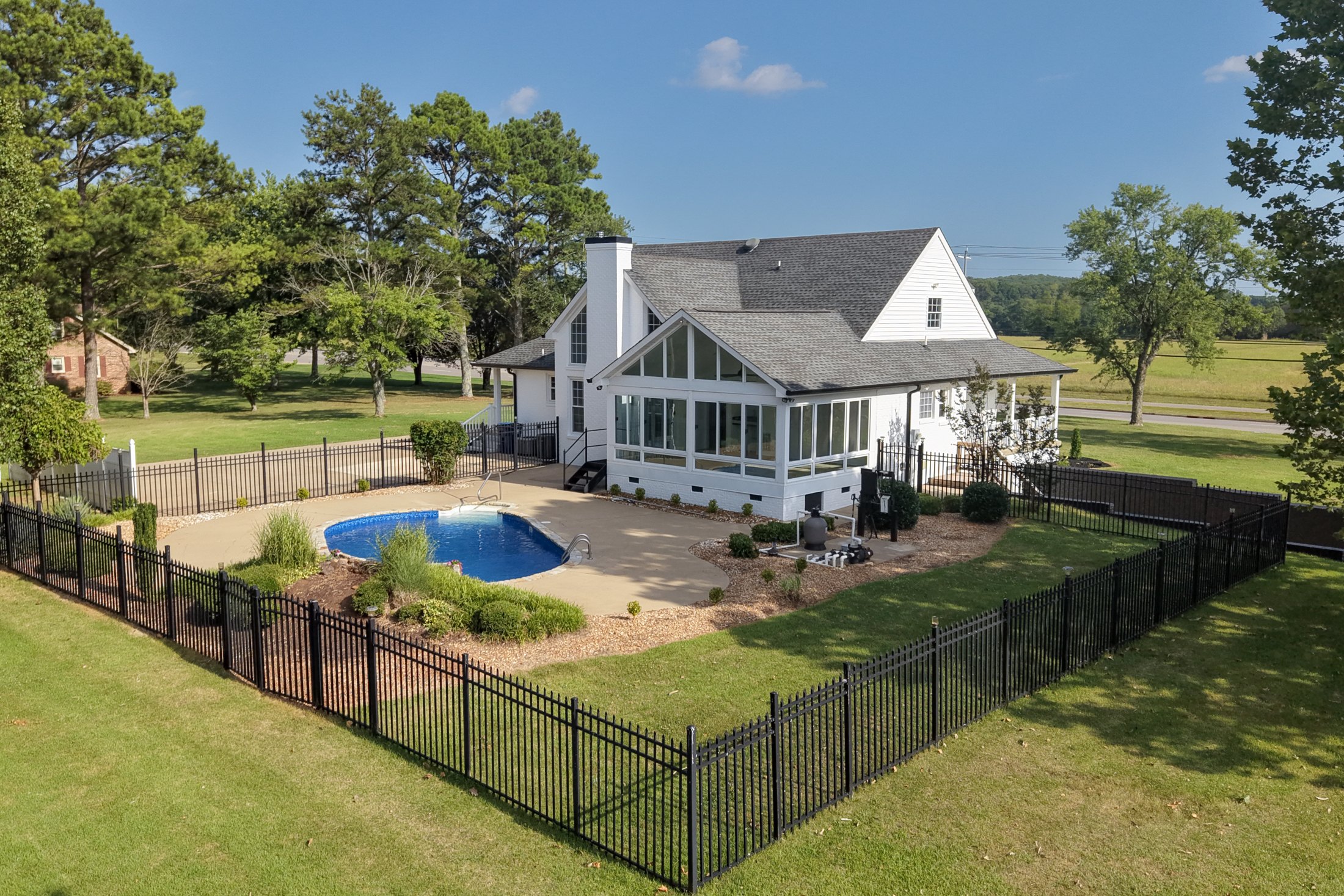 Aerial view of the home, pool, and grounds